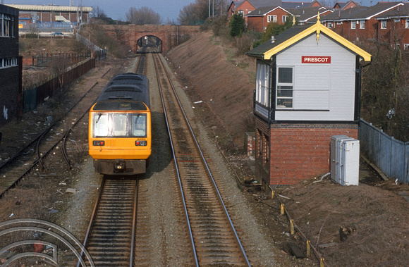 09014. 142002. Lime St -  Wigan North Western service passes the Signalbox. Prescot. 08.03.01