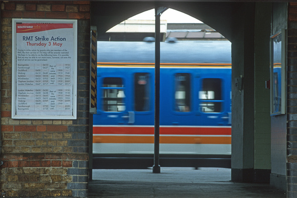 09310. RMT poster, speeding train and deserted platform. Clapham Junction. 03.05.2001