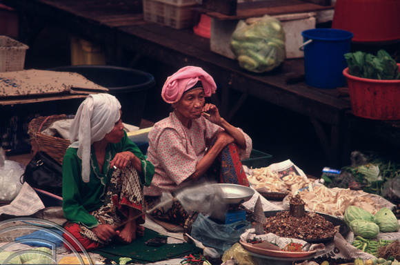 T7306. Two old women on a stall. Indoor market. Kota Baru. Malaysia. June. 1998
