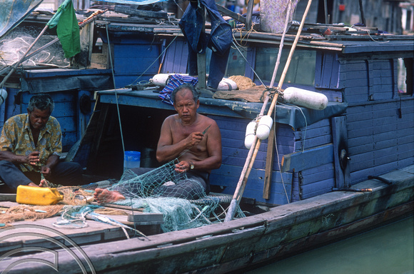 T7394. Fisherman mending his nets. Melaka. Malaysia. June 1998
