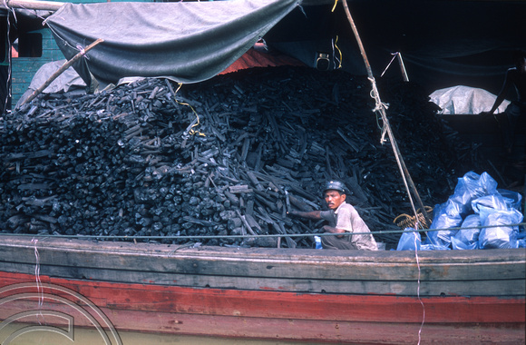 T7397. Charcoal imported by boat from Sumatra, Indonesia. Melaka. Malaysia. June 1998