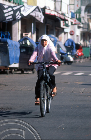 T8358. Girl on a bicycle. Yogyakarta. Java. Indonesia. December 1998