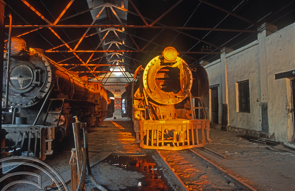 FR0450. YG 2-8-2s No's 3457 and 3318. Dumped inside the shed. Wankaner Junction. Gujarat. India. 13.02.2000.