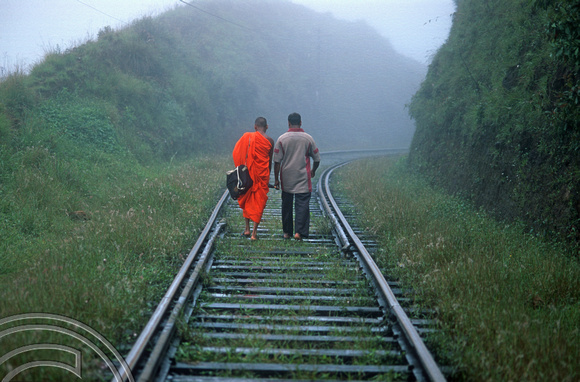 FR0953. Monk and companion walking along the railway to Haputale. Hill railway. Sri Lanka. 08.01.2003
