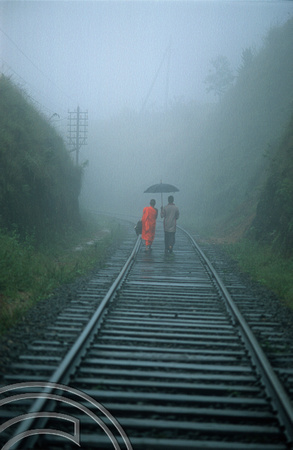 FR0954. Monk and companion walking along the railway to Haputale. Hill railway. Sri Lanka. 08.01.2003