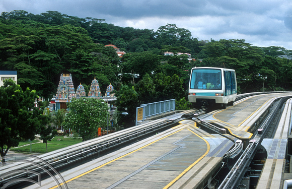 FR1126. Bukit Panjang LRT 106 passes a Hindu temple as it heads for Choa Chu Kang. Singapore. 09.09.2003