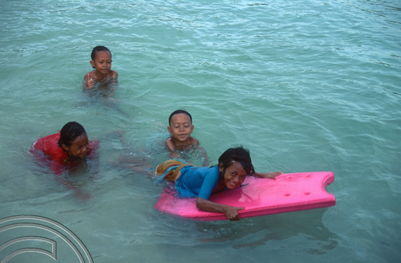 T8161. Kids playing in the sea. Padangbai. Bali. Indonesia. November 1998