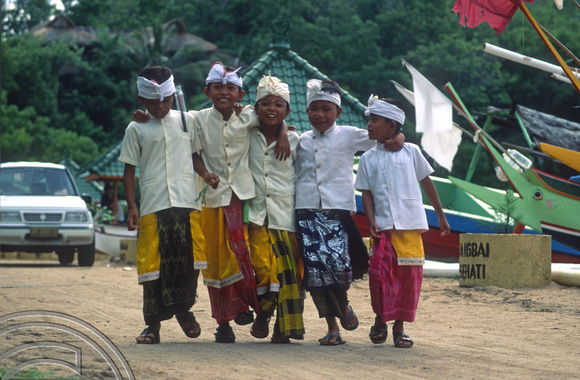 T8141. Boys returning from the temple. Padangbai. Bali. Indonesia. November 1998