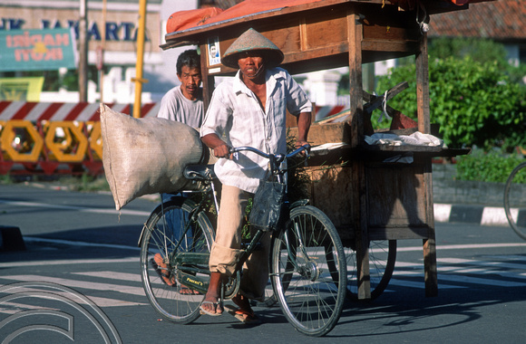 T8254. Hawler and cyclist. Yogyakarta. Java. Indonesia. November 1998