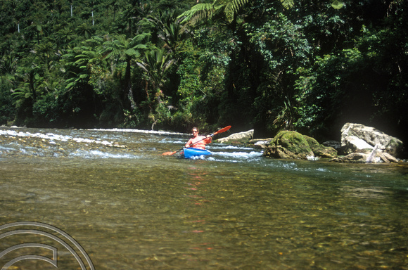 T8883. Lynn canoeing on the Pororari river valley. Punakaiki. South Island. New Zealand. 17th February 1999