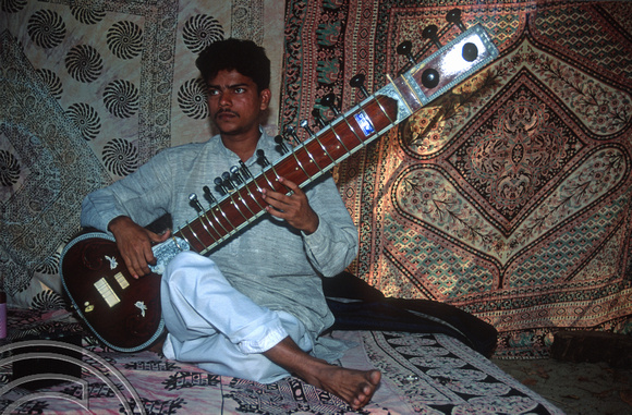 T9277. Laxmikant Khandikar playing the tampora. Double Dutch. Arambol. Goa. India. 23rd January 2000