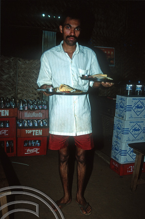 T9298. Millim serving rice plates at Sanjay's. Arambol. Goa. India. 26th January 2000