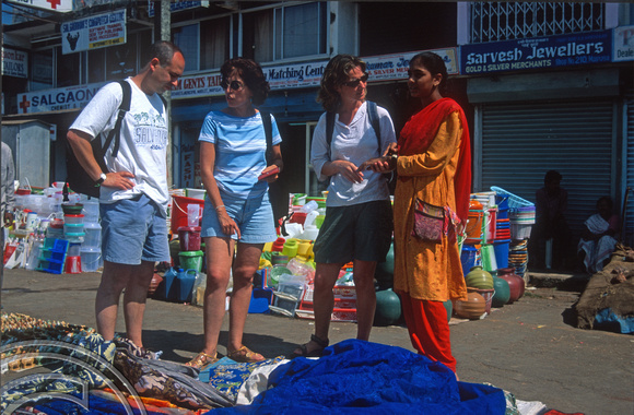 T9319. Xavier, Ana Carmen and Lynn shopping in the market. Mapsa Goa. India. 28th January 2000