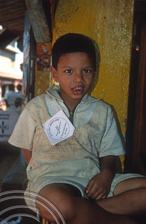 T9345. Boy wearing an election sticker. Arambol. Goa. India. 30th January 2000