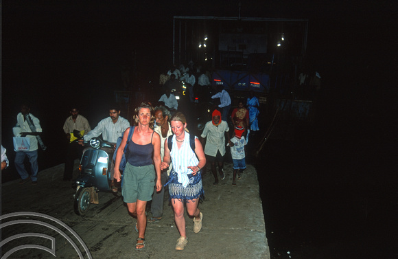 T9405. Walking off the ferry. Siolim. Goa. India. 1st February 2000