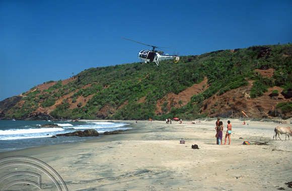 T9448. Coastguard helicopter over little beach. Arambol. Goa. India. 4th February 2000