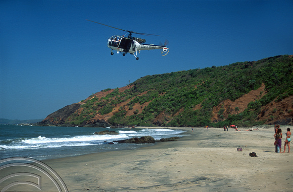 T9454. Coastguard helicopter over little beach. Arambol. Goa. India. 4th February 2000