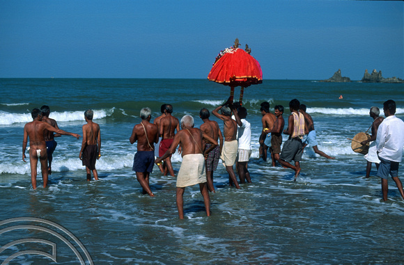 T9493. Taking the God for a swim.  An idol. Arambol. Goa. India. 5th February 2000