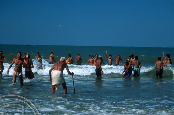 T9497. Throwing offerings into the sea. Arambol. Goa. India. 5th February 2000