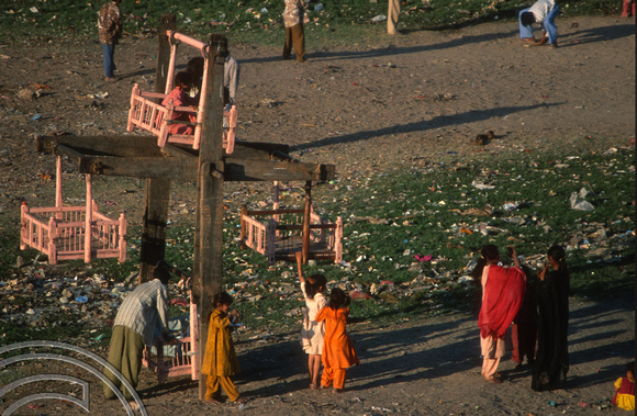T9748. Childrens wheel in slums on the riverbank under the Holiday Inn. Ahmedabad. Gujarat. India. 15th February 2000