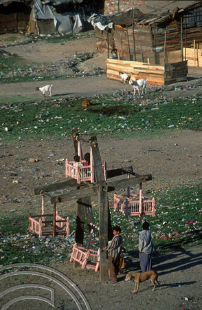 T9739. Childrens wheel in slums on the riverbank under the Holiday Inn. Ahmedabad. Gujarat. India. 15th February 2000