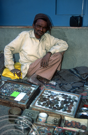 T9736. Man selling old coins. Ahmedabad. Gujarat. India. 15th February 2000
