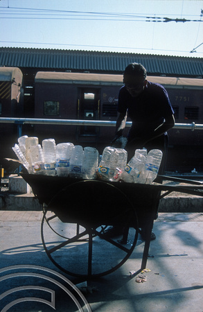 T9759. Collecting old plastic bottles at the station. Ahmedabad. Gujarat. India. 16th February 2000