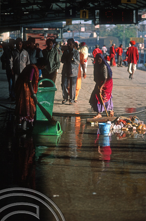 T9826. Woman sweeping and washing the station platform. Ahmedabad. Gujarat. India. 21st February 2000