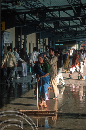 T9827. Woman sweeping and washing the station platform. Ahmedabad. Gujarat. India. 21st February 2000