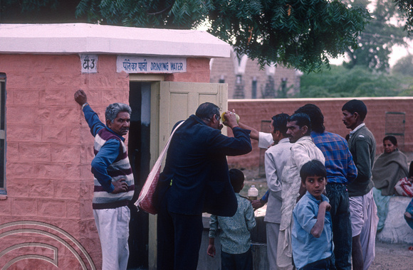 T4397. Handing out drinking water at a railway station. Rajasthan. India. December 1993.