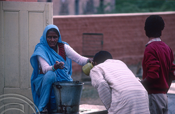 T4398. Handing out drinking water at a railway station. Rajasthan. India. December 1993.