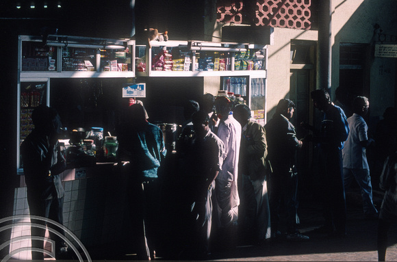 T4408. Crowding around a tea stall. Murgao. Goa. India. December 1993.