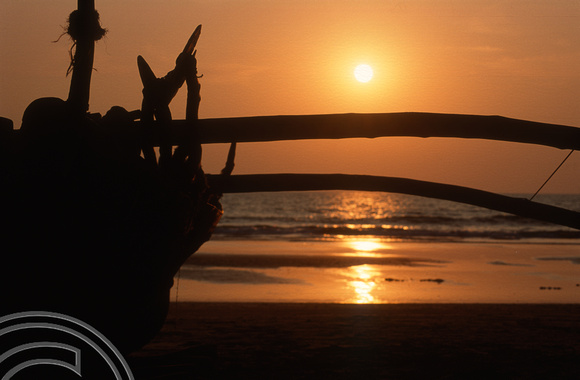 T4440. Sunset over a fishing boat. Arambol. Goa. India. December 1993.
