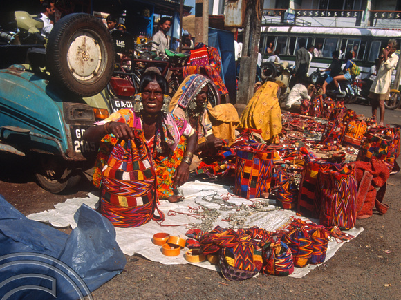 T4453. Tribal woman selling bags in the market. Mapusa. Goa. India. December 1993.
