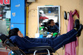 DG71964. Barber asleep. Old Town. Hanoi. Vietnam. 8.1.11.