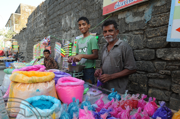 DG76593. Holi colour sellers. Diu. India. 18.3.11.