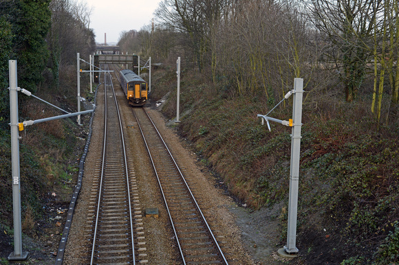 DG170807. The march of the electrification masts. Thatto Heath. 15.2.14.