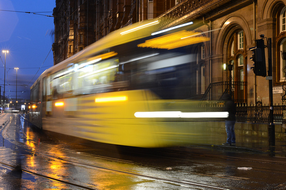 DG201324.Tram blur. St Peters Square. Manchester. 21.11.14.