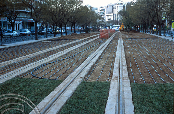 18036. installing the irrigation system between the new tram tracks. Athens. Greece. February 2004.
