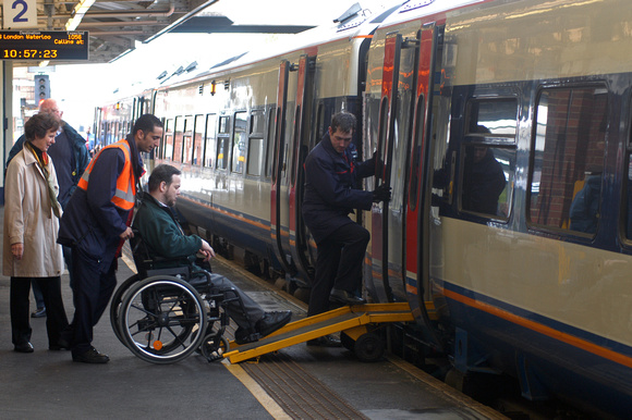 DG00524. Wheelchair passenger boards train. Woking. 21.4.04.